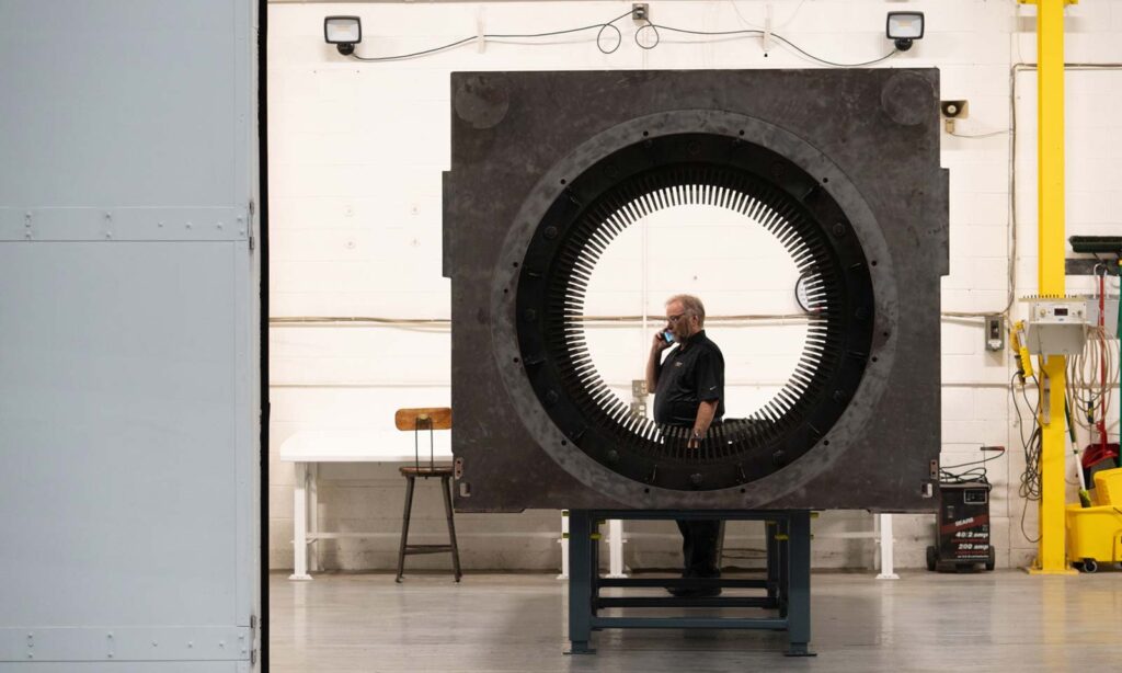 Large motor in a large cleanroom with Al Jeske, Vice President of Operations at HECO.