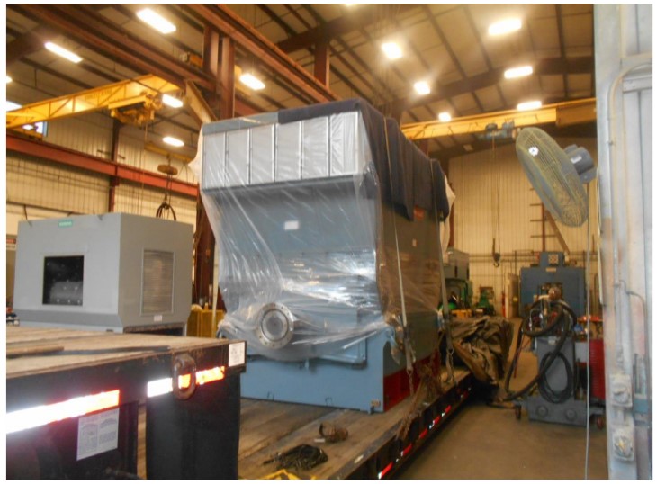 painted and packaged motor loaded onto a tractor trailer